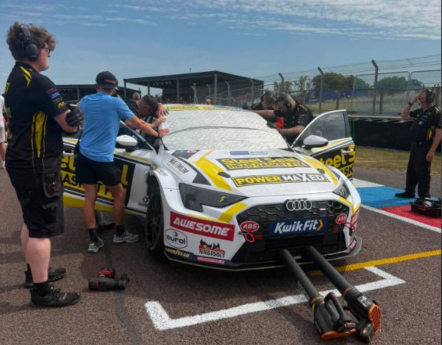The Power Maxed Racing crew working on the front of the Awesome-sponsored #17 Audi S3 on the Thruxton grid, tyre blankets and cooling fans still attached