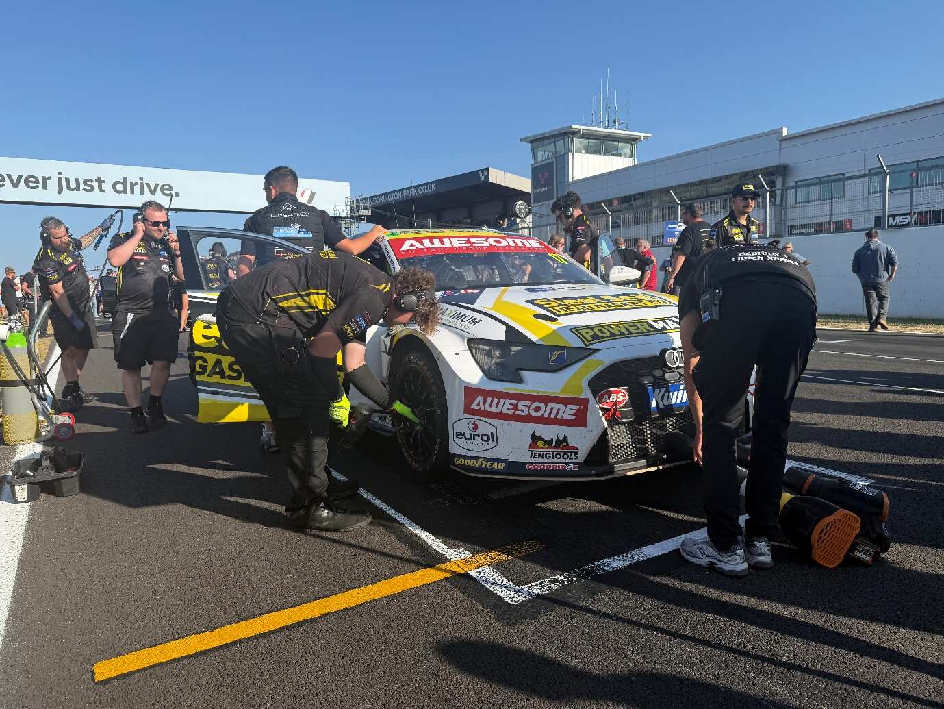 The Awesome-sponsored #17 Steel Seal Power Maxed Racing Audi S3 on the Donington Park grid with the crew working on the car before the start